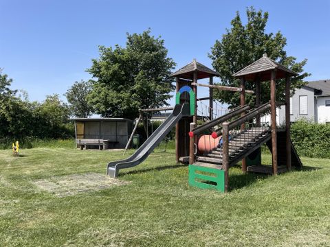 Children's climbing frame made of wood, with integrated metal slide.