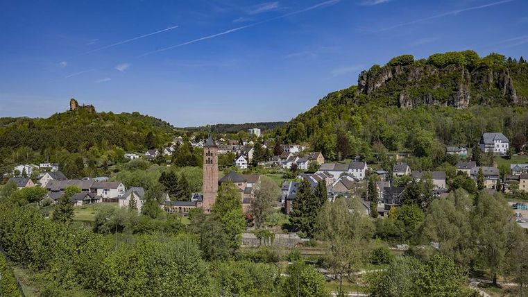 View from a distance of the Redeemer Church Gerolstein with Dolomite rock in the background